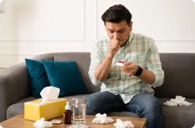 Person coughing from allergies with medicine from primary care clinic for relief