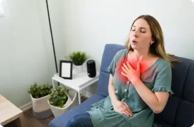 Woman experiencing acid reflux symptoms receiving primary care for chest discomfort