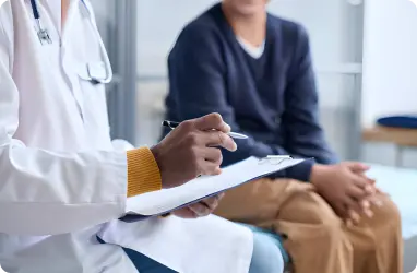 primary care physician and person discussing annual physical protocol 