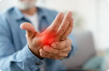 a man's hand suffering from arthritis pain seeking primary care services